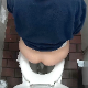 A hidden camera records a woman taking a shit while sitting on a toilet in a public restroom. She puts toilet paper in the toilet to help dull the plop sounds. Little does she know it is all on camera. Presented in 720P HD. About half a minute.